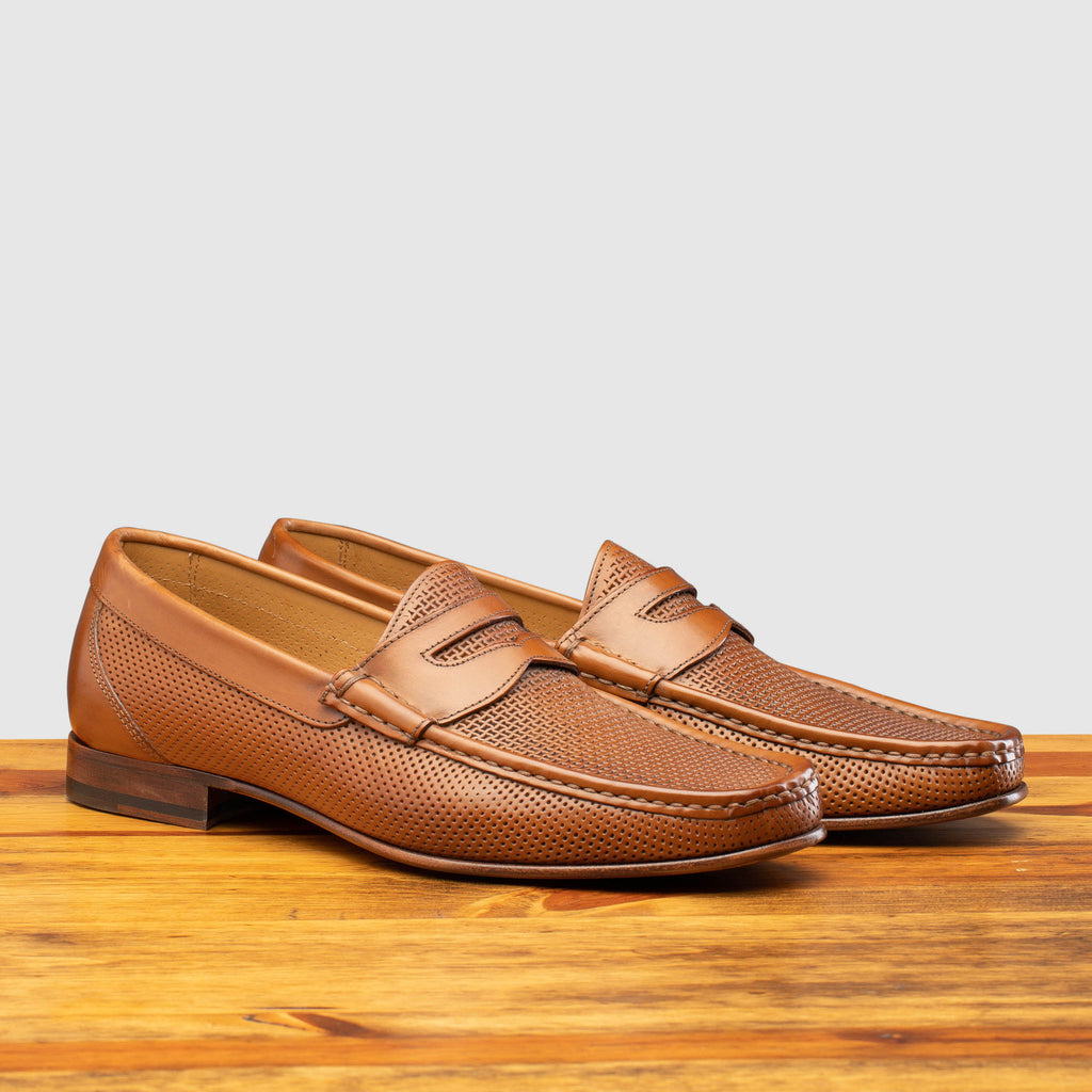 Pair of Q479-M Calzoleria Toscana Brick Tony-M Loafer on top of a wooden table