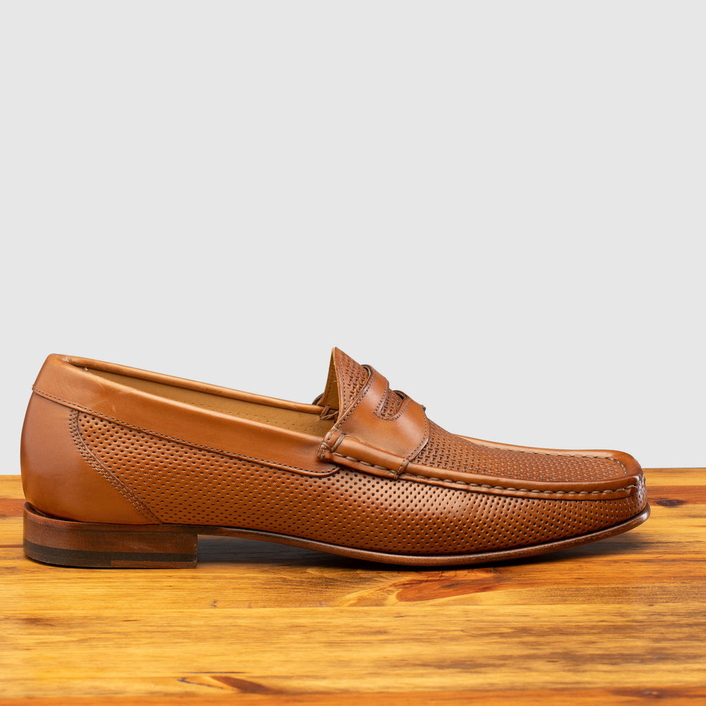 Side profile of Q479-M Calzoleria Toscana Brick Tony-M Loafer on top of a wooden table