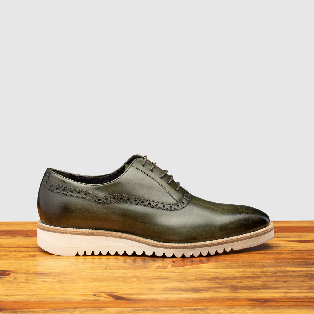 Side profile of Q548 Calzoleria Toscana Emerald Green Onice Two Piece-Oxford on top of a wooden table