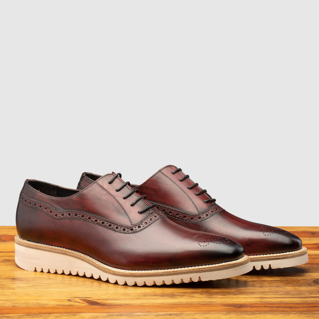 Pair of Q548 Calzoleria Toscana Burgundy (Porpora) Onice Two Piece Oxford on top of a wooden table