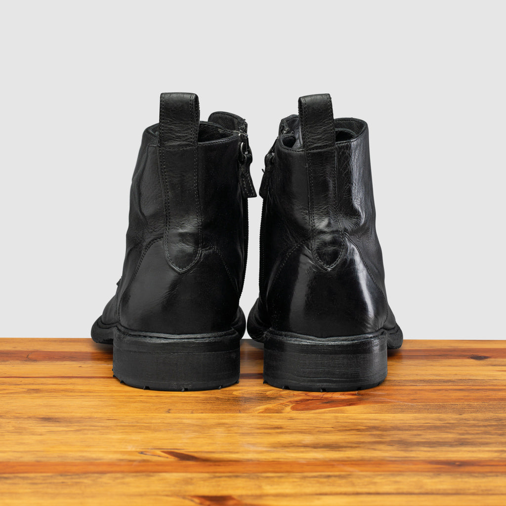 Back profile of Q549 Calzoleria Toscana Black Combat Boot on top of a wooden table