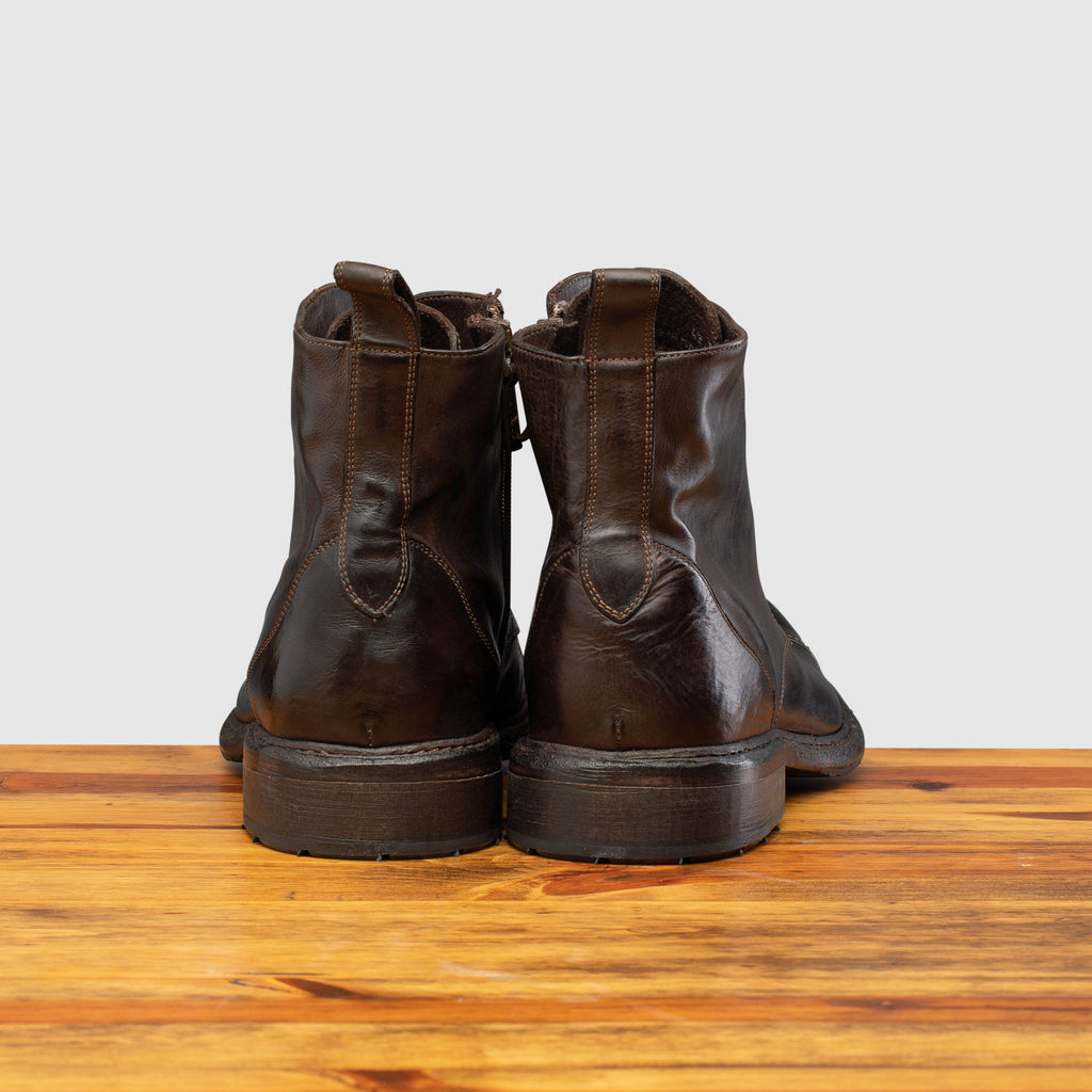 Back profile of Q549 Calzoleria Toscana Dark Brown Combat Boot on top of a wooden table