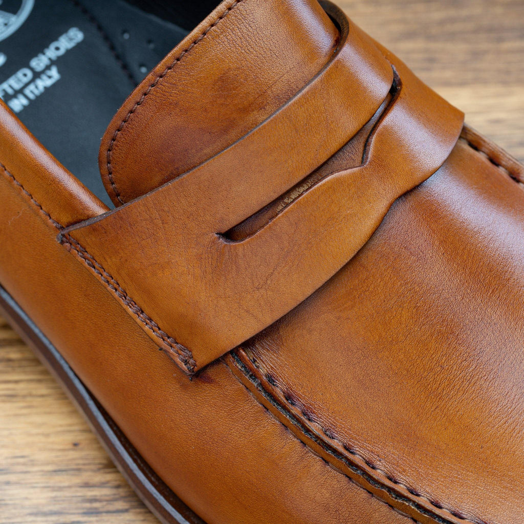 Up close photo of the penny strap of the Calzoleria Toscana Santor Collegiate Loafer in Dark Caramel