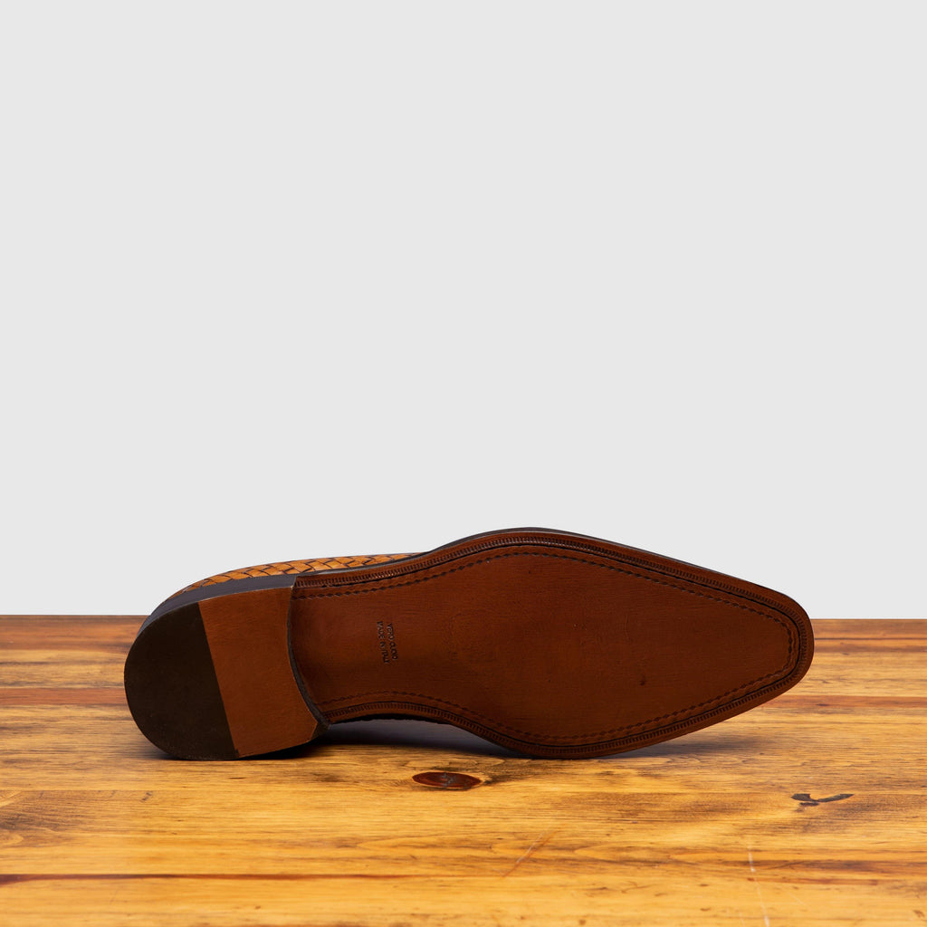 Full leather outsole of 5373 Calzoleria Toscana Chestnut Woven Lace-Up on top of a wooden table