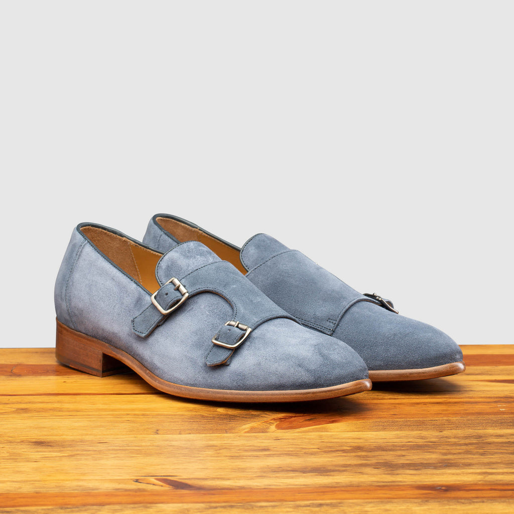 Pair of Z893 Calzoleria Toscana Jean Blue Double Strap Low Vamp Slip-On on top of a wooden table
