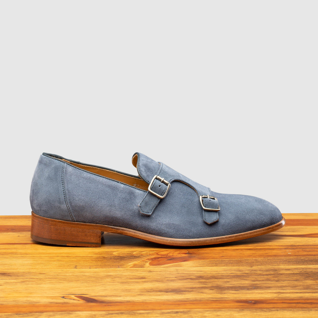 Side profile of Z893 Calzoleria Toscana Jean Blue Double Strap Low Vamp Slip-On on top of a wooden table