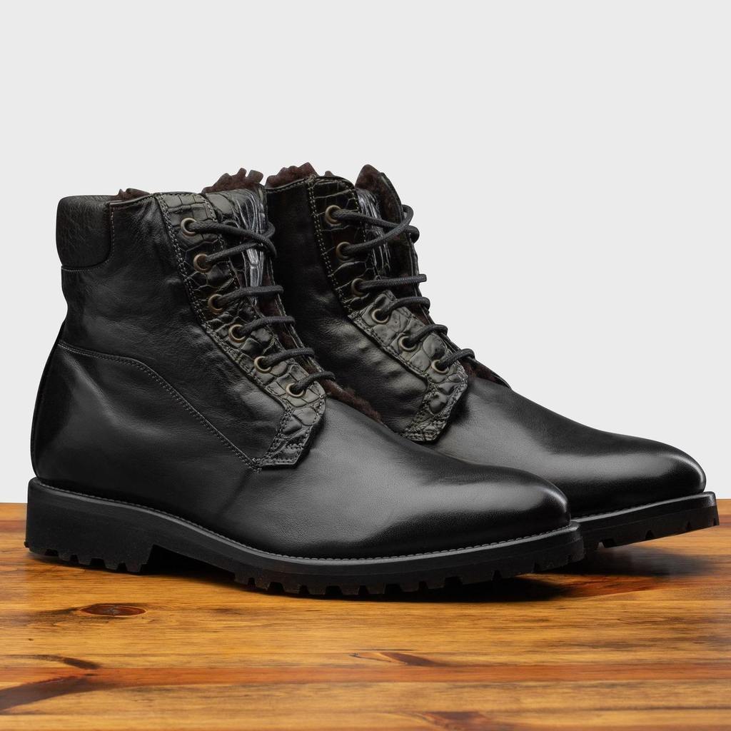 Pair of 3236 Calzoleria Toscana Black Shearling Boot on top of a wooden table