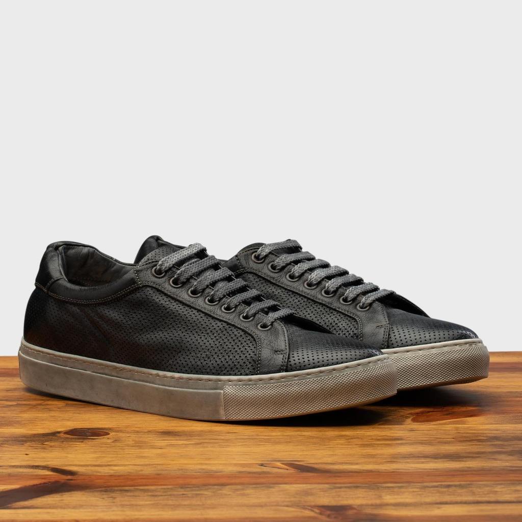 Pair of the 3042 Calzoleria Toscana Black Benso sneaker on top of a wooden table