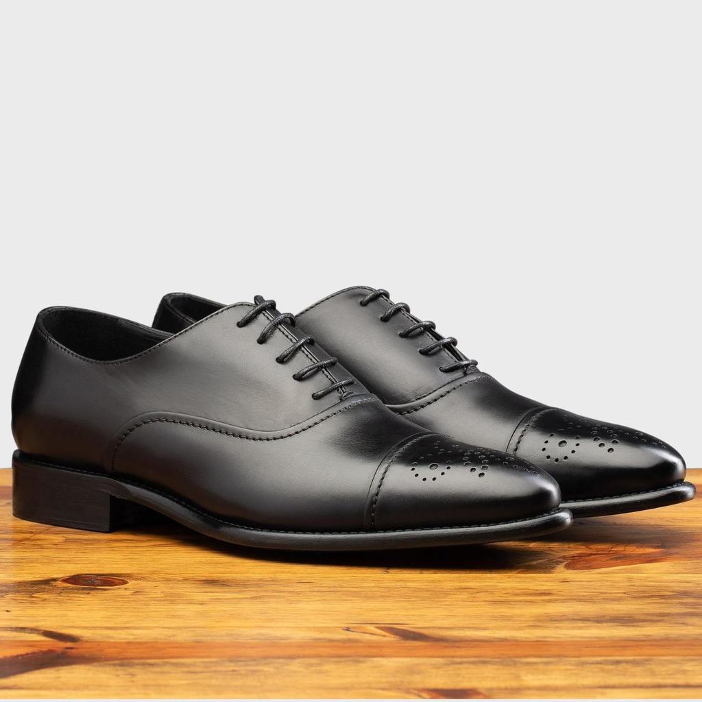 Pair of the 2361 Calzoleria Toscana Black Cayenne Calf Cap Toe on top of a wooden table